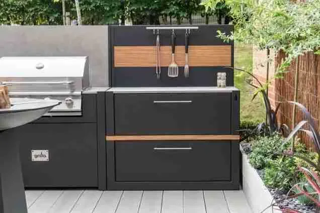 grillo kitchen cupboard unit with doors next to gas bbq and chefs anvil