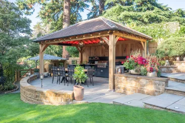 Outdoor kitchen in stratford upon avon under wooden pergola on patio