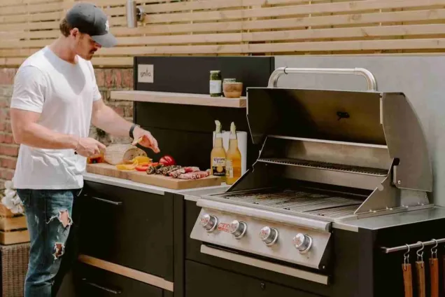 man cooking on grillo outdoor kitchen in chelsea london