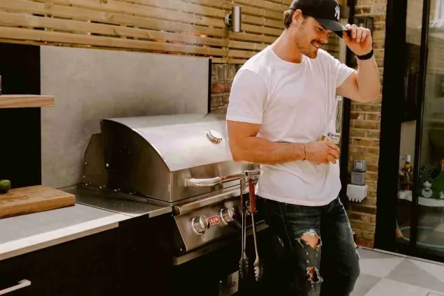 outdoor kitchen in chelsea london with man standing in front