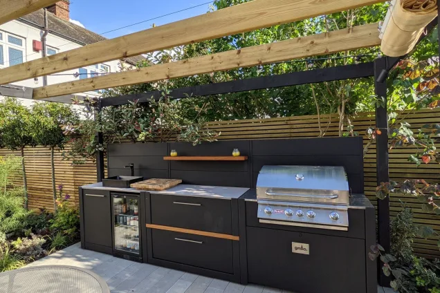 Outdoor kitchen with gas bbq and fridge and bin cabinet and storage on patio