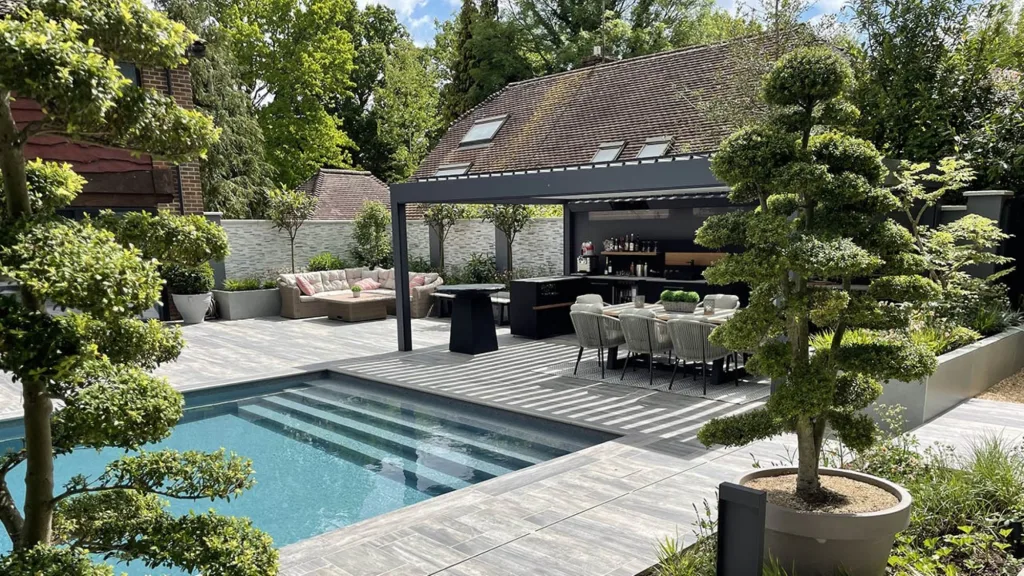 outdoor kitchen under roof next to swimming pool