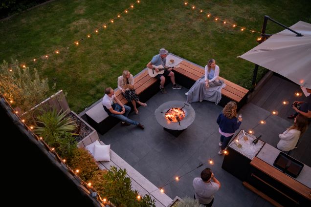 top down angle of people sitting on bench seating around chefs anvil