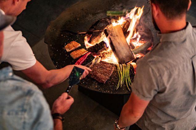people cooking meal on chefs anvil short