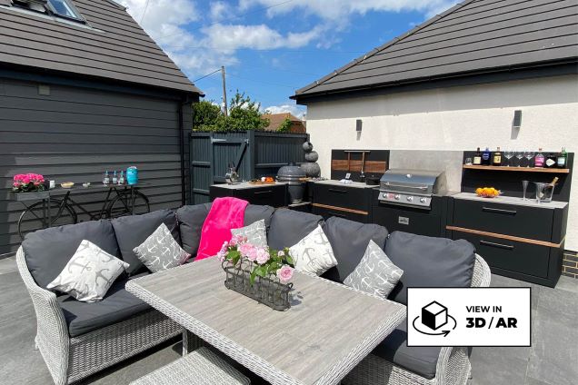 large seating area with outdoor kitchen behind