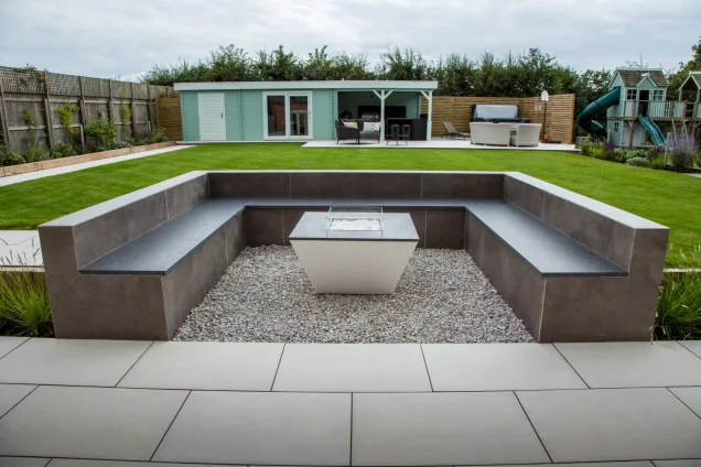 seating area overlooking roofed outdoor kitchen in Warwickshire