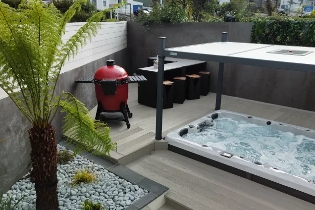 outdoor kitchen in patio corner next to roofed hot tub in St Ives, Cornwall