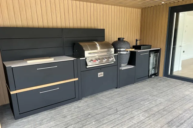 outdoor kitchen under roof with Bull gas grill and Gusto charcoal BBQ in Sevenoaks, Kent