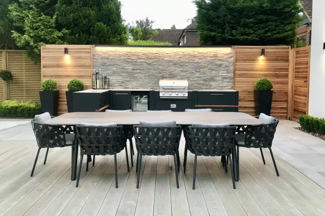 Outdoor kitchen in kent on decking with large outdoor table