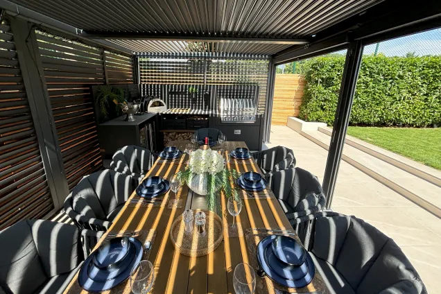 Outdoor kitchen in Burwell, Cambridge with table set for meal