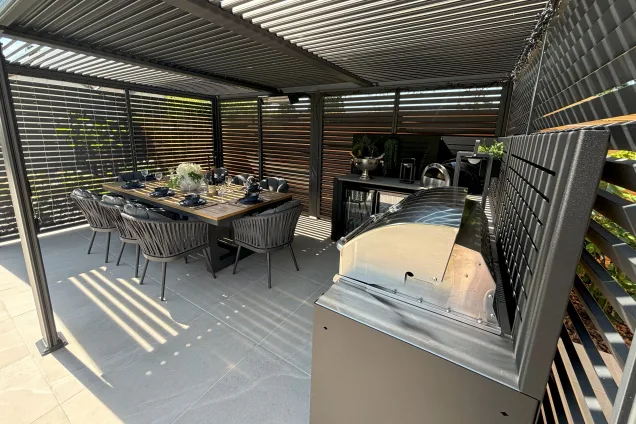 Outdoor kitchen in Burwell, Cambridge with gas bbq and table set for meal