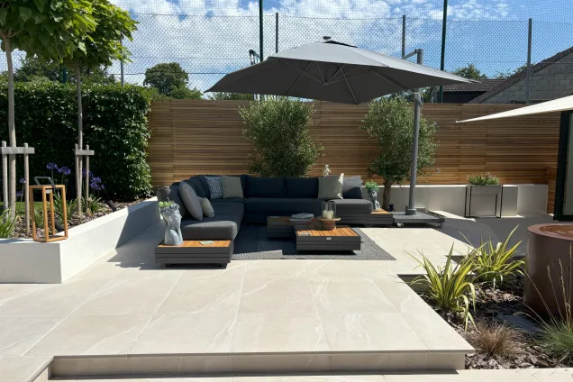 Outdoor kitchen in Burwell, Cambridge with seating area under parasol