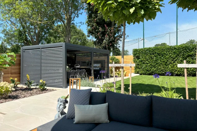 Outdoor kitchen in Burwell, Cambridge under pergola with dining area