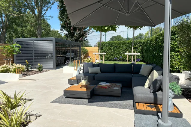 Outdoor kitchen in Burwell, Cambridge with parasol to shade seating area