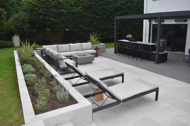 Outdoor kitchen in Caldy, Wirral on patio with deck chairs and seating area