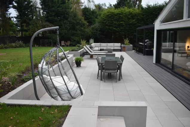 Outdoor kitchen in Caldy, Wirral on patio with deck chairs and seating area
