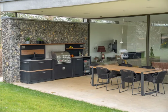 Grillo outdoor kitchen on Grand Designs with dining table