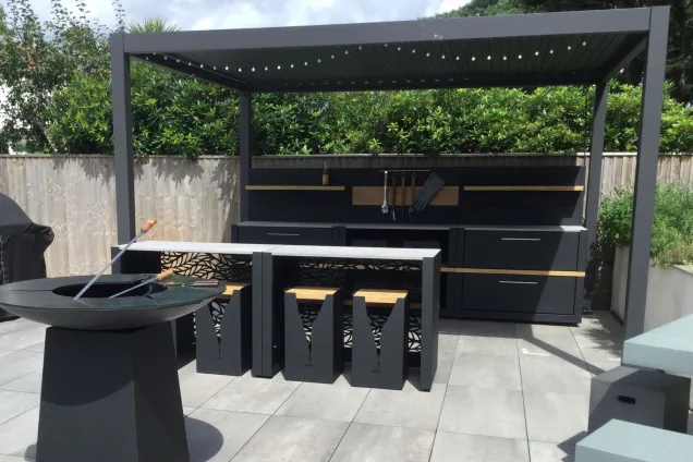 Outdoor kitchen in dorset with bar seating and chefs anvil