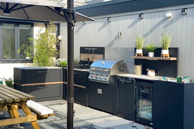 L-shaped outdoor kitchen with built-in fridge and Bull gas grill in Middleton, Milton Keynes