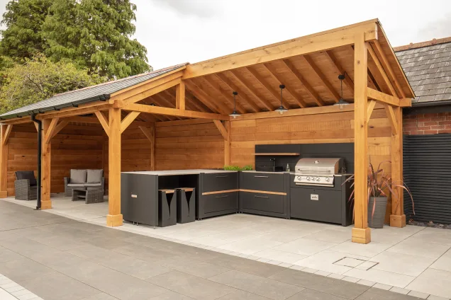 Outdoor kitchen in Cheshire under wooden pergola on patio