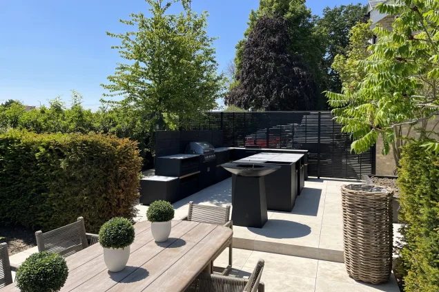 wooden table overlooking aesthetic outdoor kitchen on patio in Little Waltham, Chelmsford, Essex