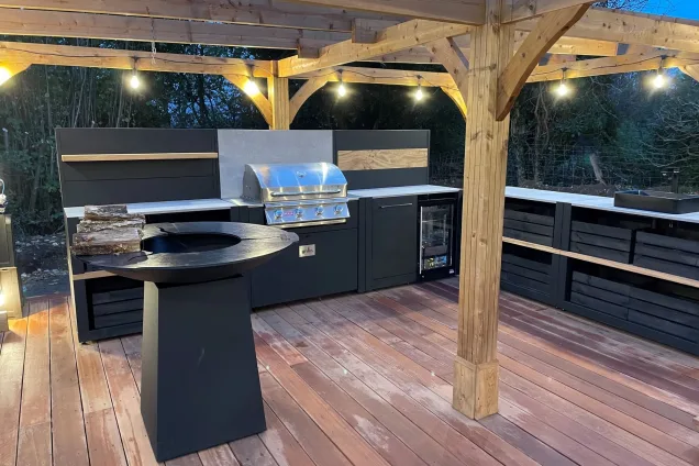 outdoor kitchen with hotplate BBQ, gas BBQ and built-in fridge and storage cabinets in Little Marlow