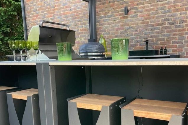 Outdoor kitchen in Tadworth with bull gas bbq and gusto bbq and bar table and stools