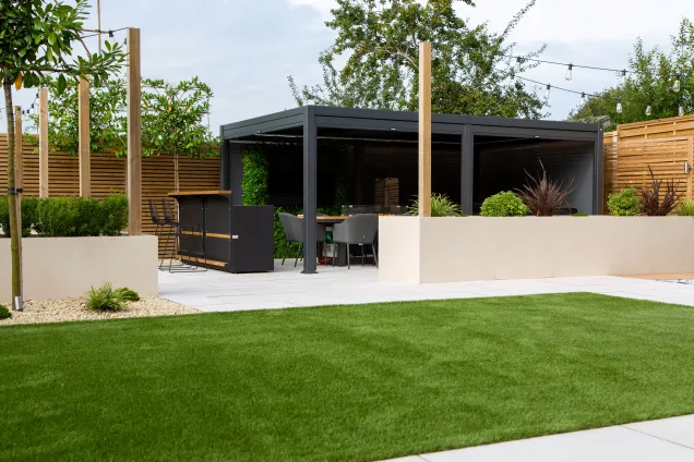 Outdoor kitchen in Leicestershire under pergola in landscaped garden with outdoor bar