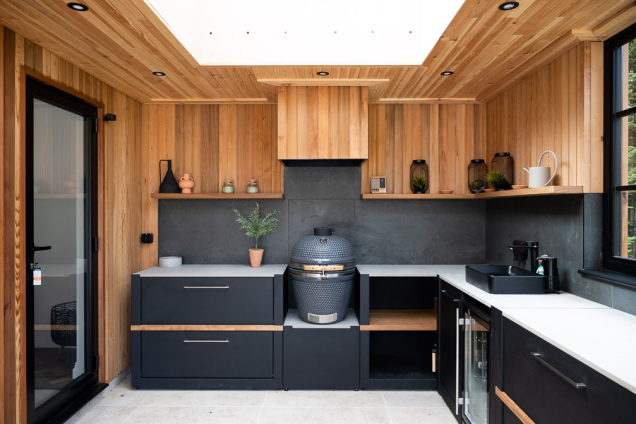outdoor kitchen in west malling with gusto charcoal bbq in wooden clad garden building