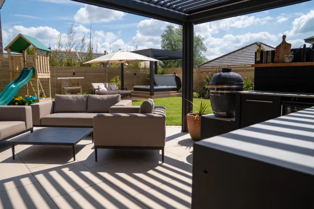 Gusto charcoal BBQ in L-shaped outdoor kitchen under pergola in Tamworth, Staffordshire