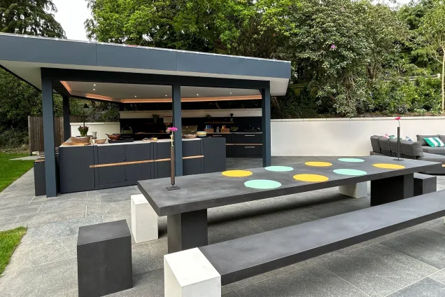Outdoor kitchen in Farnham on patio with dining table
