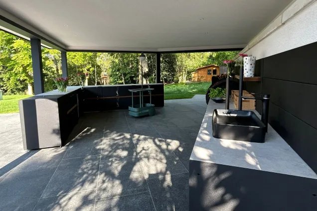 Outdoor kitchen under pergola in Farnham with bull gas bbq and storage units and sink