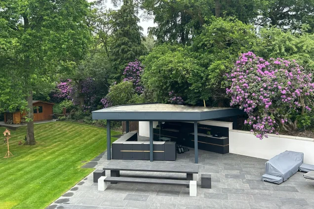 Outdoor kitchen under pergola in Farnham with outdoor dining table
