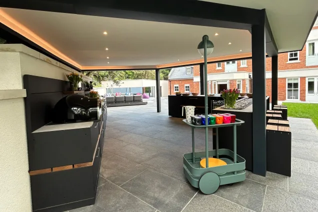 Outdoor kitchen under pergola in Farnham with wood fired pizza oven