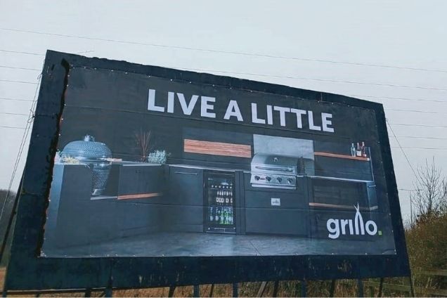 Grillo kitchen billboard saying live a little