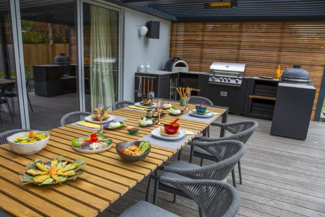 Outdoor kitchen in Colchester with dining table under pergola
