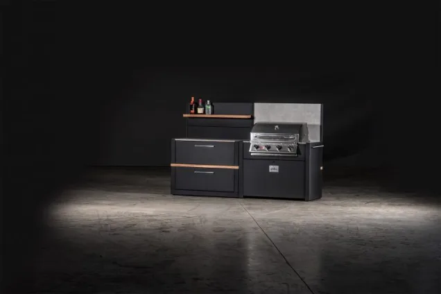 outdoor kitchen with gas bbq and storage cabinet with feature walls