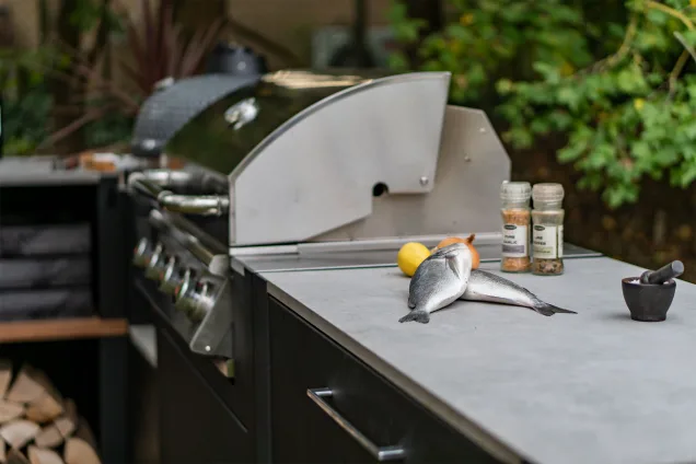 grillo Bull bbq with fish and lemons on the porcelain worksurface