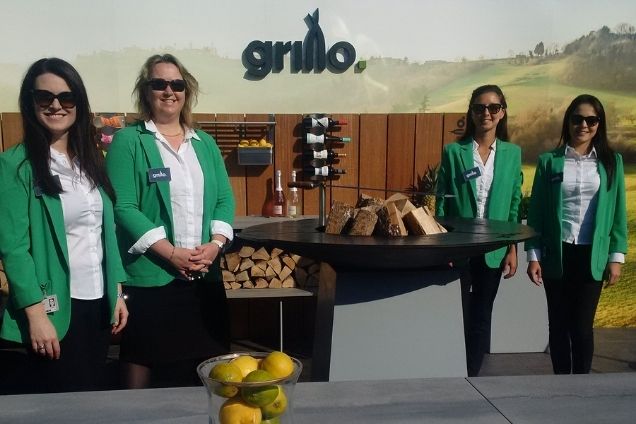 people standing in outdoor kitchen at show