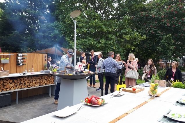 people standing around grillo kitchen and cooking at Chelsea Flower Show