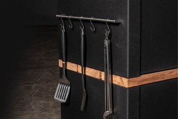 Outdoor kitchen tool rail attachment on the side of a storage cabinet