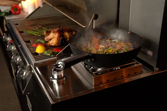 Side-burner next to a Grillo outlaw bbq with wok in outdoor kitchen