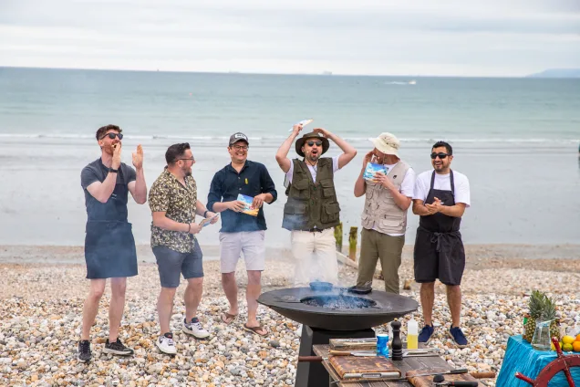 sorted food cast behind a chefs anvil