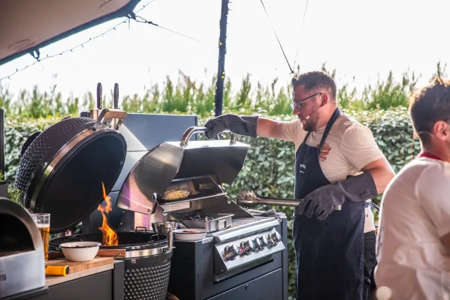 sorted food man cooking in grillo outdoor kitchen on bull gas bbq