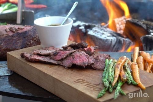 meat on chopping board on grillo chefs anvil bbq