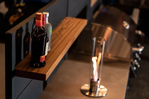 grillo cabinet with shelf feature wall with drinks on it