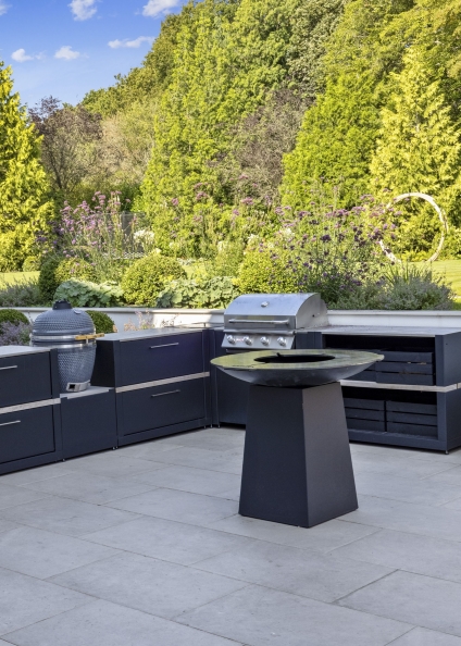 outdoor kitchen in ashtead on patio with trees in background