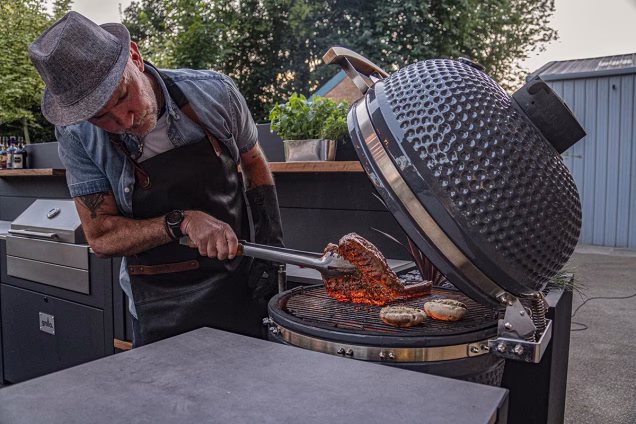 man flipping meat on grillo gusto