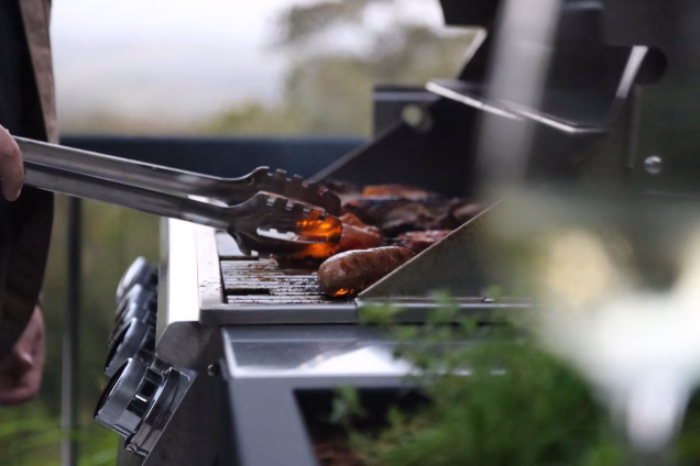 grillo outdoor kitchen with person cooking on bull gas grill station