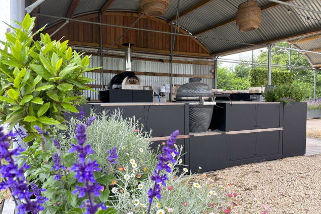 outdoor kitchen cafe with BBQ and purple flowers